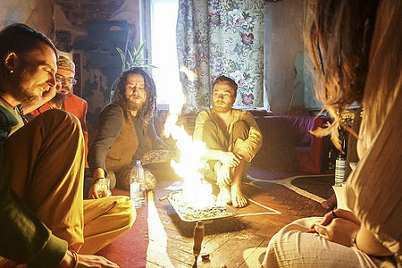 Commune members in St.Peterburg have decided to gather around the fire in their flat to discuss important issues. Temporary Autonomous Zone series, 2016